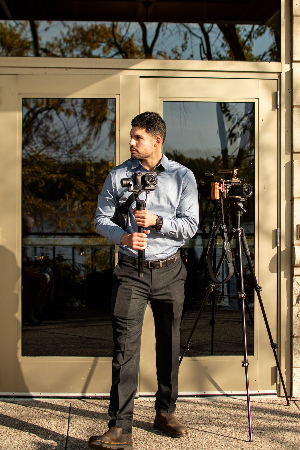 Elias Baruch holding camera gear at a wedding venue