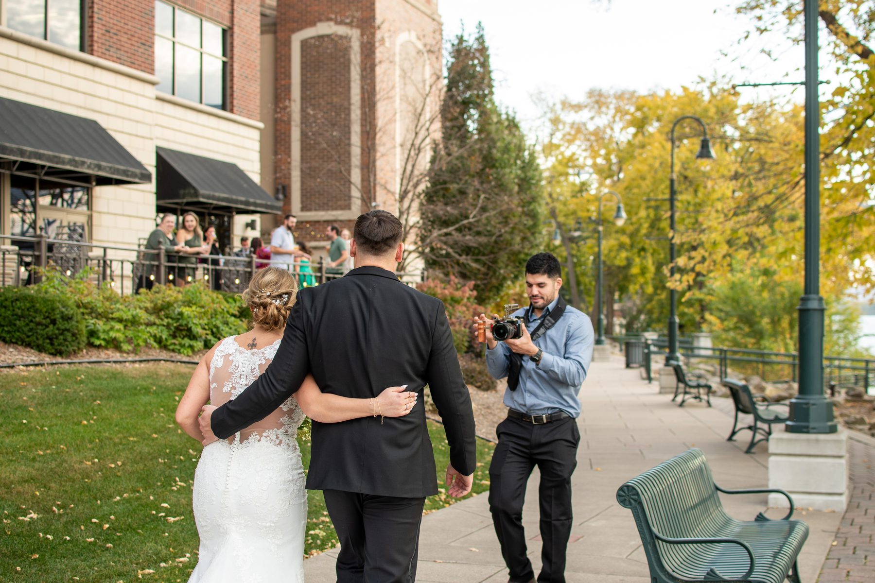 Elias filming a couple outside their wedding venue